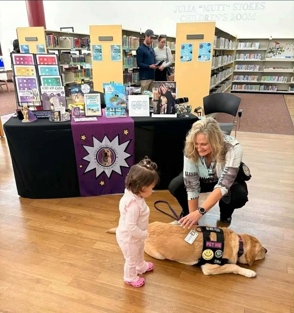 Estie meeting a toddler at a library author event