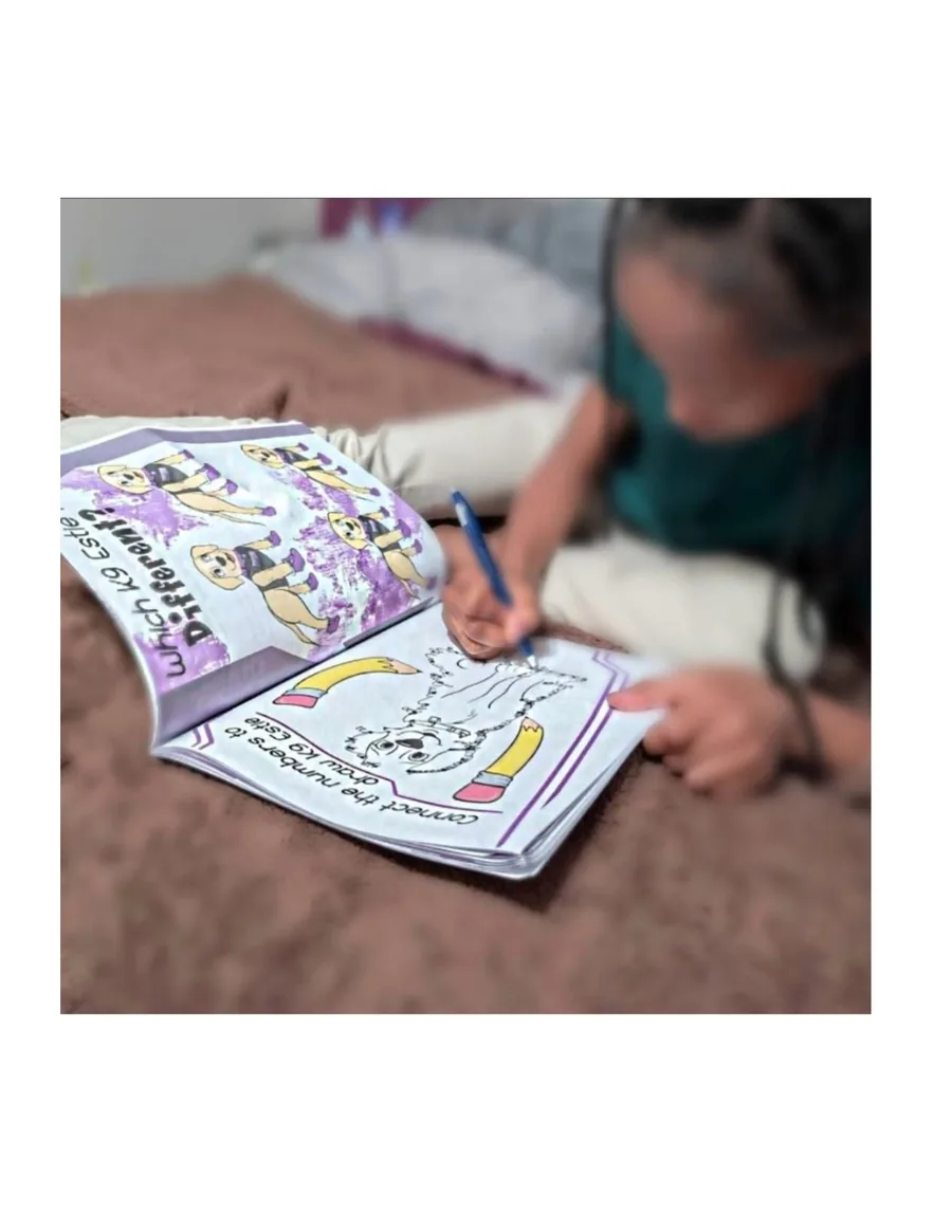 A child coloring in the Estie activity book