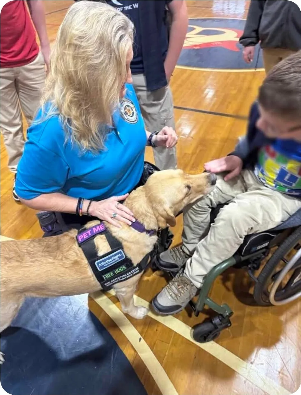 Estie greeting a student in a wheelchair